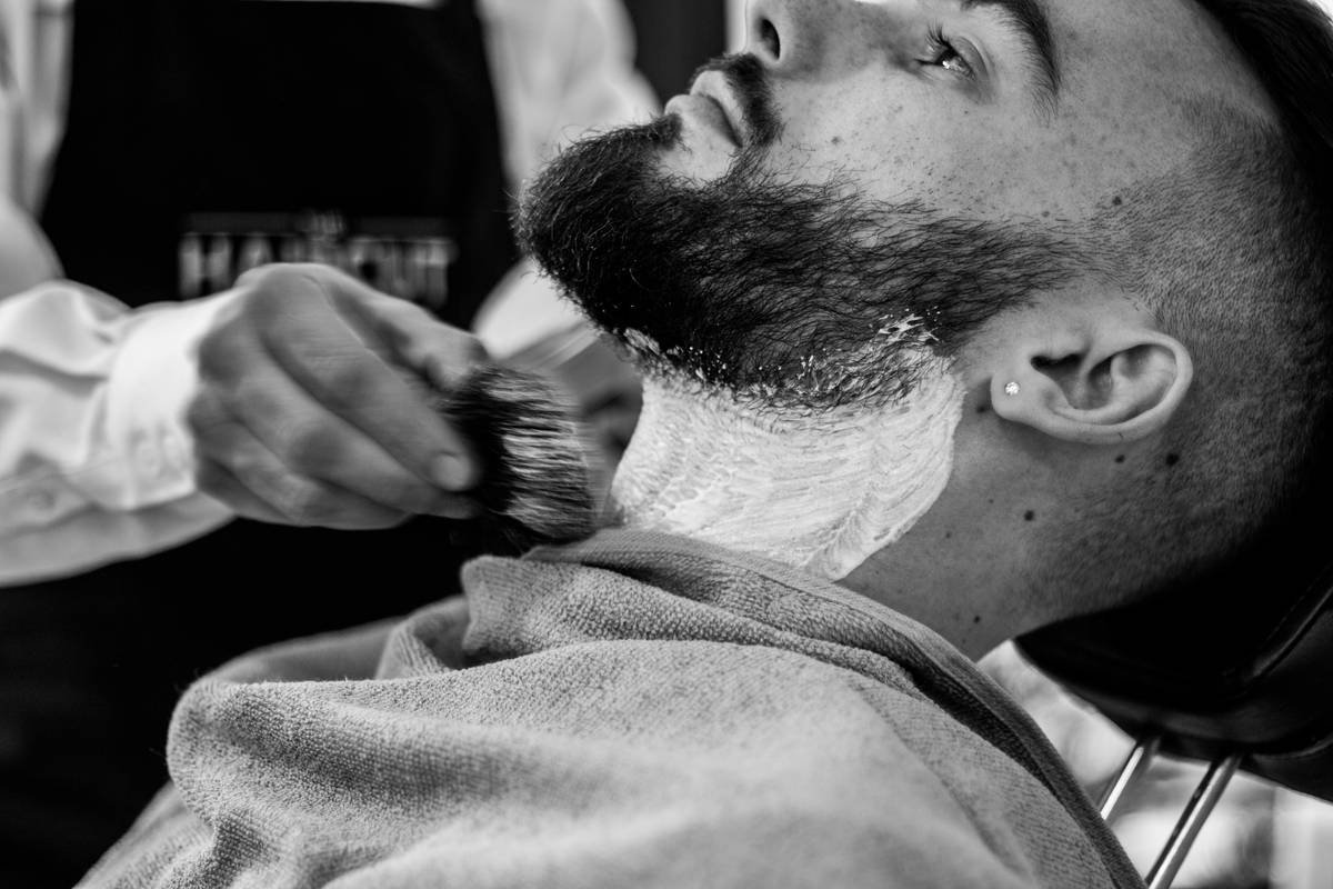 Hand applying thick shaving gels for coarse hair to stubble before shaving